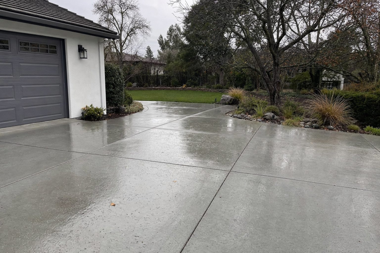 Freshly sealed concrete driveway with a wet sheen before the rains