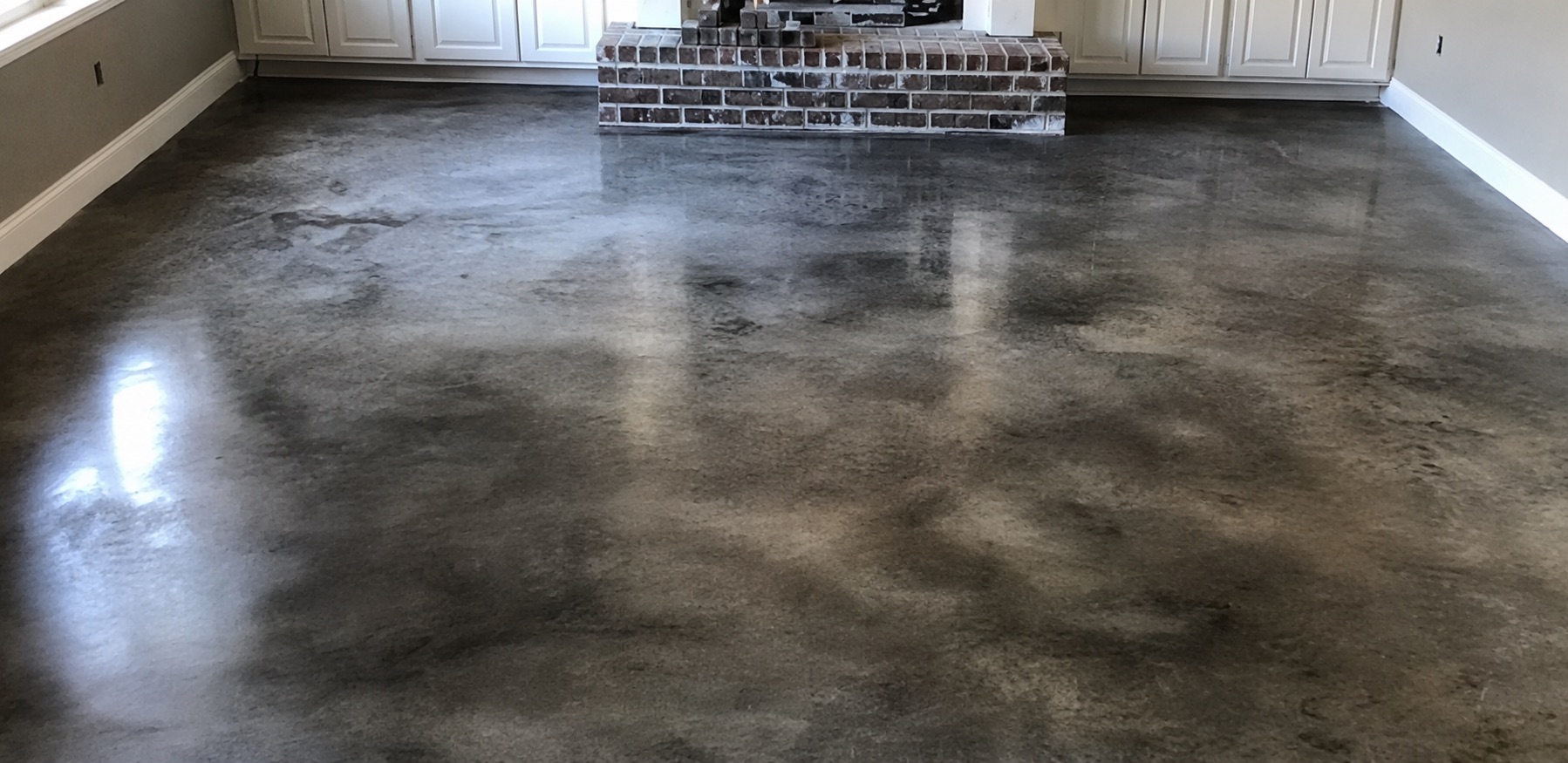A finished, richly toned acid-stained concrete floor